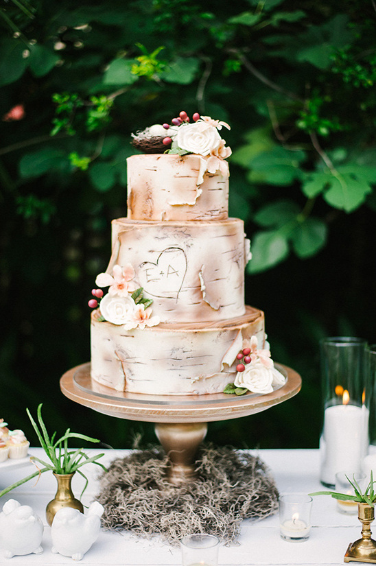 Rustic wedding cake with birch bark design and floral accents