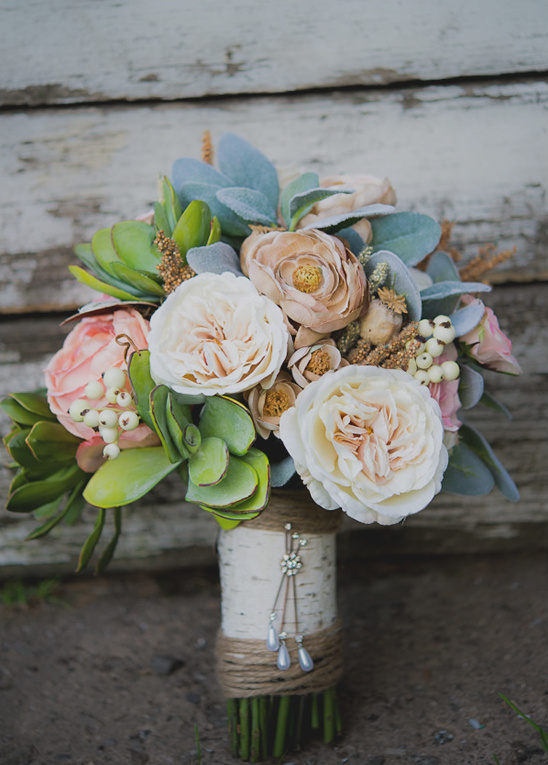 Beautiful wedding bouquet with roses, succulents and rustic touch