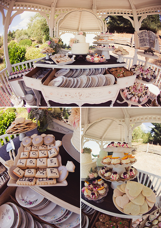 Wedding dessert table decorated with cake and cookies under a gazebo