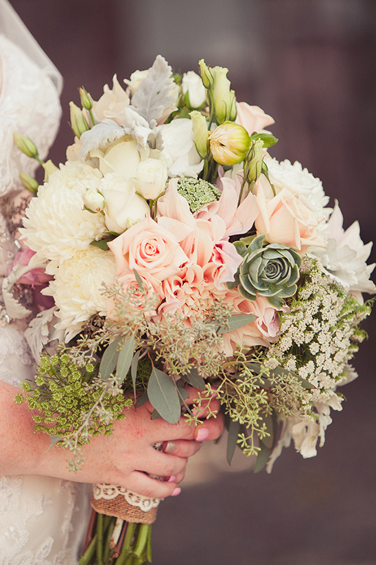 Elegant bridal bouquet with soft pink and white flowers held