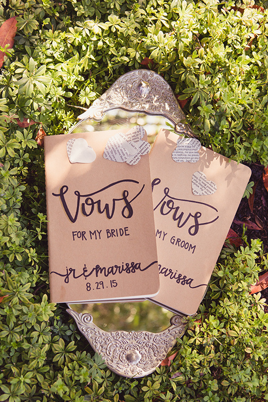 Wedding vows book with decorative mirror, set in nature