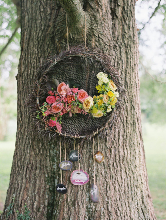 Floral wreath and personalized stones hanging from a tree