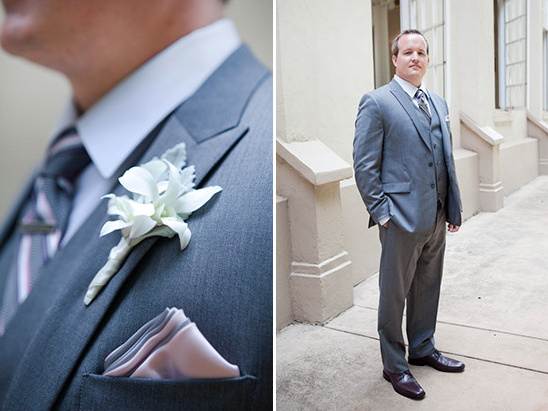 Groom in a grey suit with a flower boutonniere, elegant style