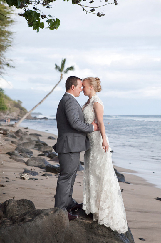 Romantic beach wedding with a bride and groom touching foreheads