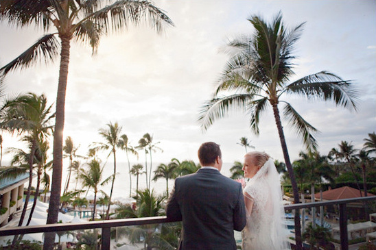 Bride and groom enjoying the view of palm trees and the ocean
