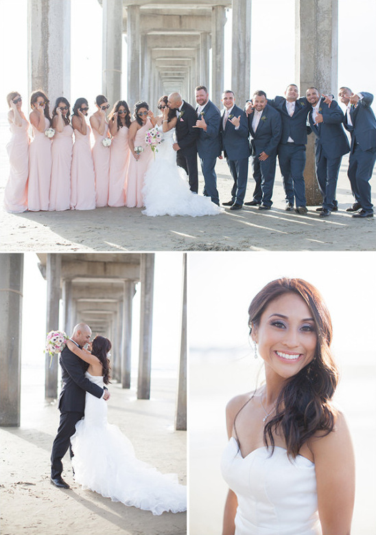 Beach wedding party with bride and groom posing