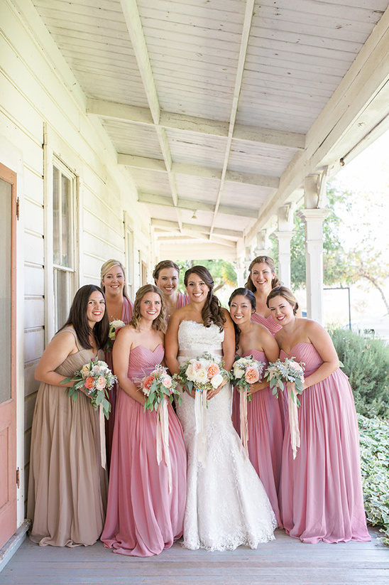 Bride and bridesmaids smiling on wedding day