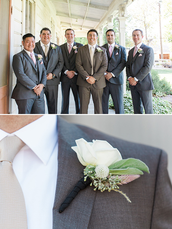Wedding party groomsmen with floral boutonnieres posing