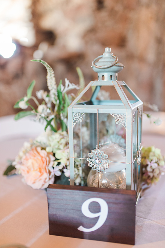 Elegant wedding table centerpiece with lantern and floral decor