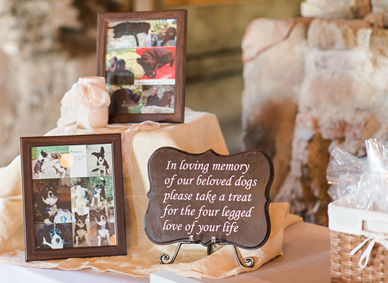 Memorial display with dog photos and a loving message for guests