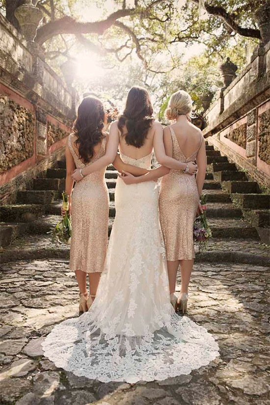 Bride and bridesmaids embrace on stone steps