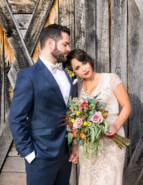 Rustic wedding portrait of stylish bride and groom