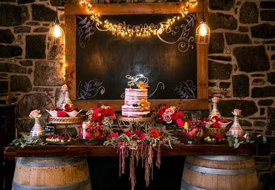 Rustic wedding dessert table with cake and flowers