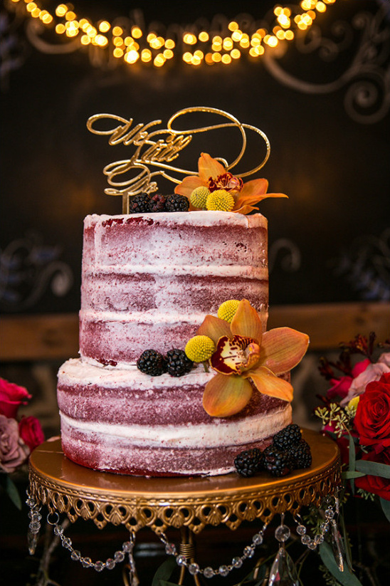 Rustic red velvet wedding cake with floral accents