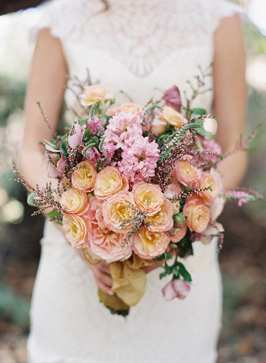 Bride holding a stunning pink and peach bridal bouquet