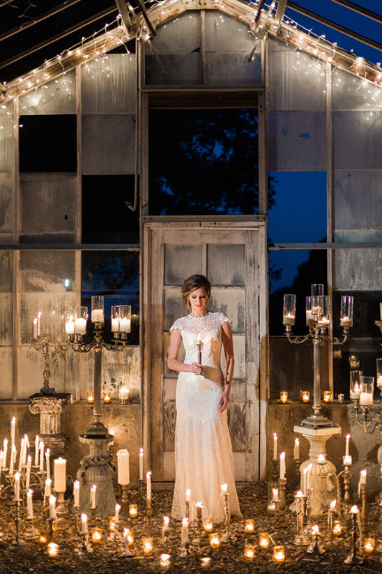 Elegant woman in white dress among romantic candles