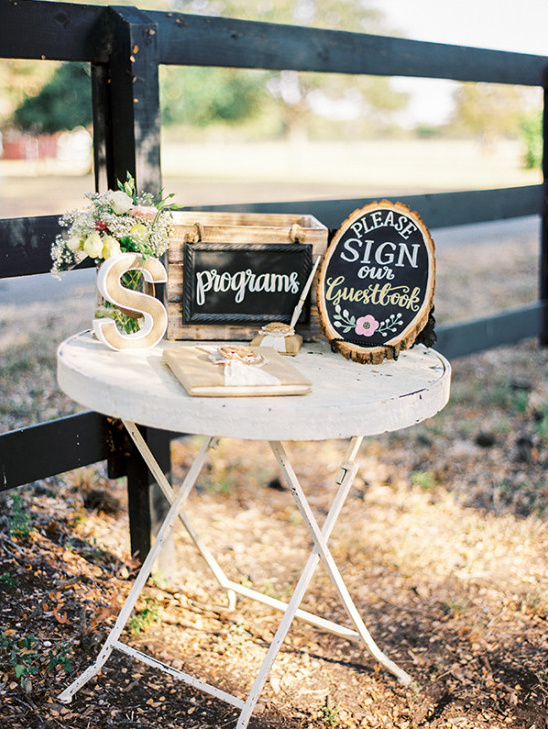 Rustic wedding guestbook and program table display