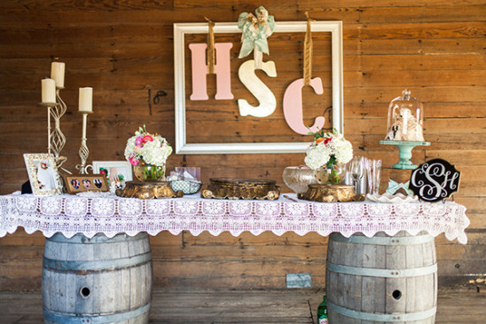 Rustic wedding table setup with flowers and initials