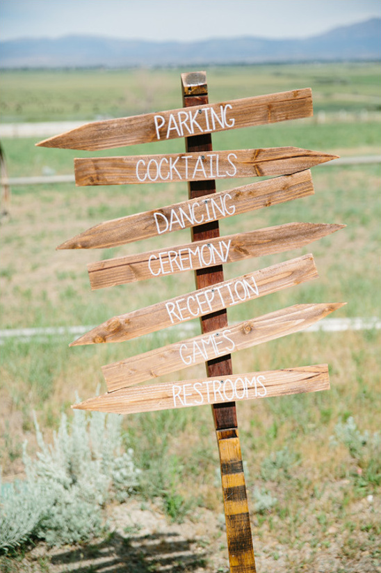 Rustic wedding signpost with directions for guests