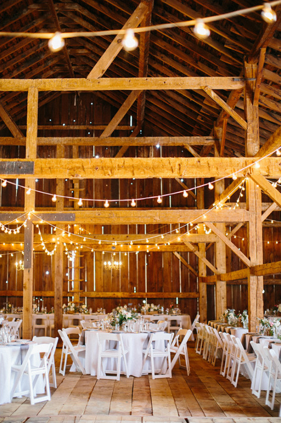 Rustic barn wedding reception with string lights