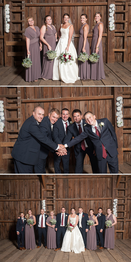 Wedding party poses in front of barn wood backdrop