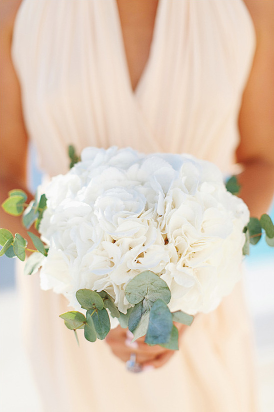 Bride holding a white flower and eucalyptus bouquet