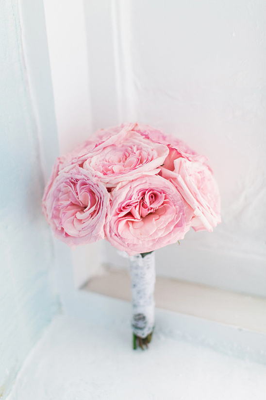 Beautiful pink rose wedding bouquet on white ledge