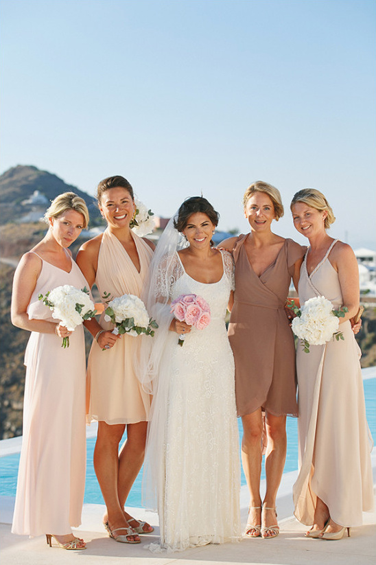 Bride and bridesmaids in neutral gowns at destination wedding