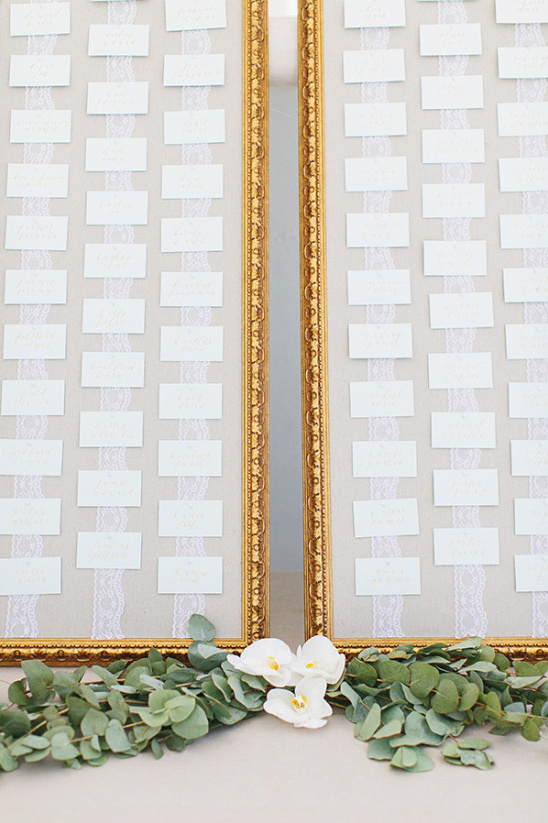 Wedding seating chart with orchids and eucalyptus