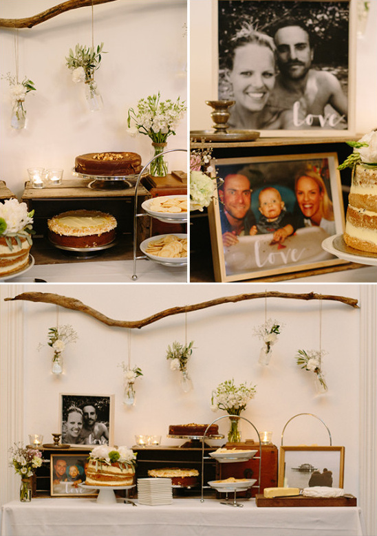 Rustic wedding dessert table with family photos and cakes