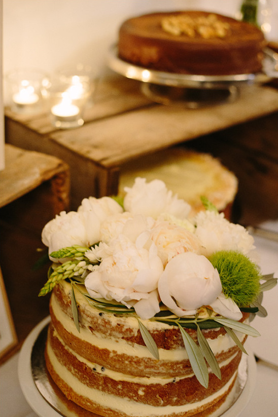 Naked cake with white flowers for rustic wedding event