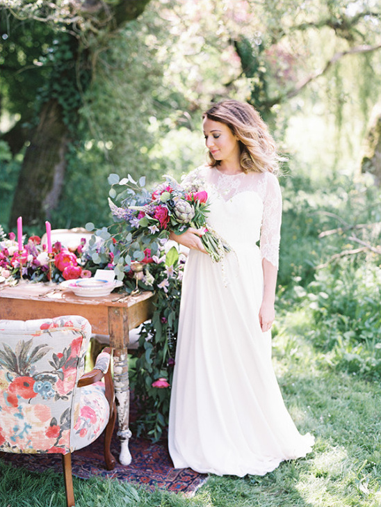 Elegant bride with floral bouquet in garden setting