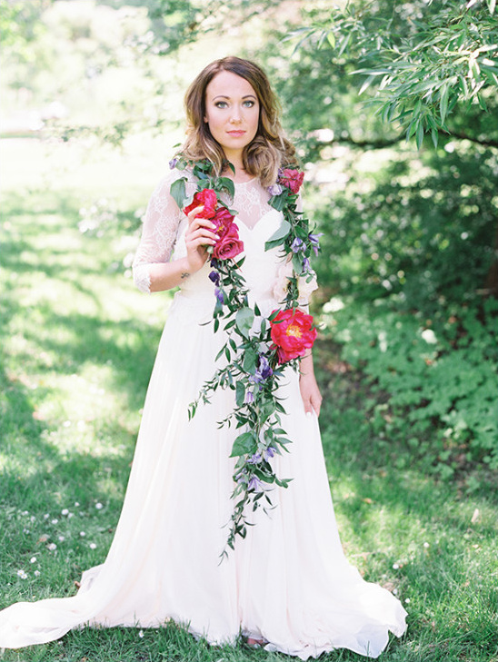 Bride in white gown with floral garland