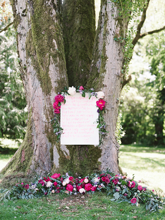 Wedding poem displayed on tree with flowers