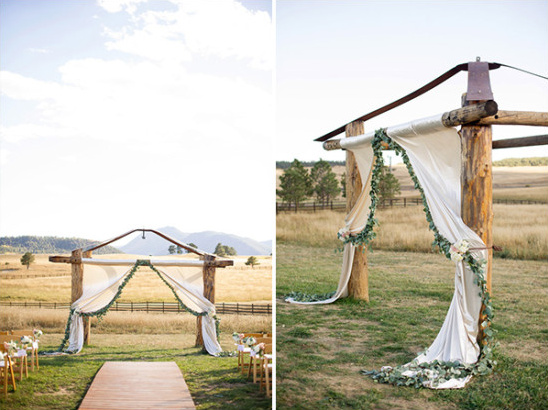 Rustic outdoor wedding ceremony arch with flowing fabric