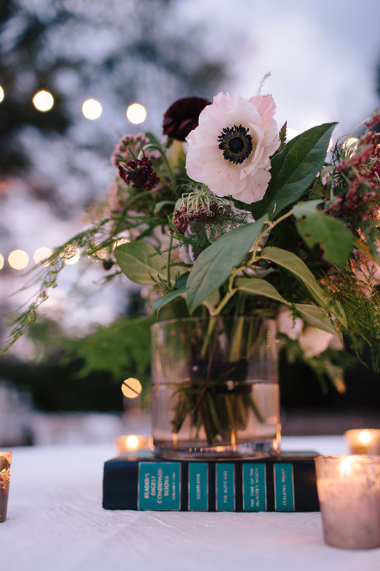 Elegant floral arrangement on books with candlelights