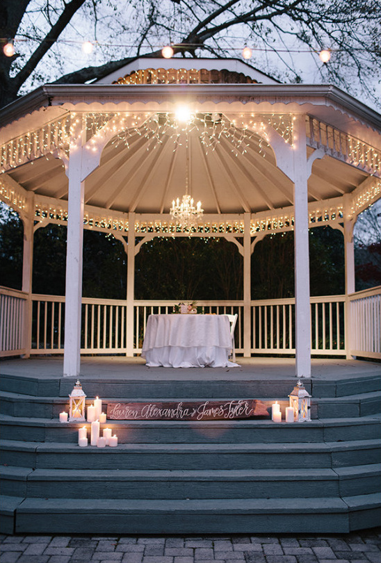 Outdoor gazebo lit with candles for a romantic wedding