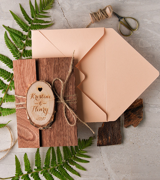 Rustic wood wedding invitation with twine and ferns