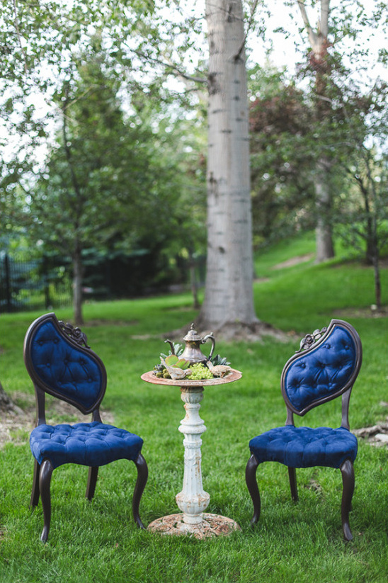 Elegant blue garden chairs and tea table in garden