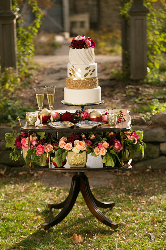 Elegant wedding cake and flower decor on outdoor table