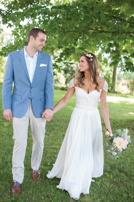 Happy couple walking hand-in-hand on their wedding day