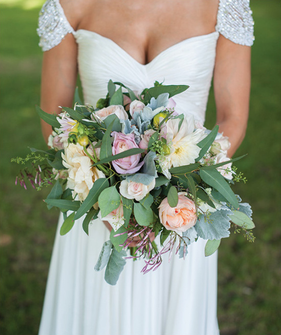 Bride holding a pastel wedding bouquet of roses