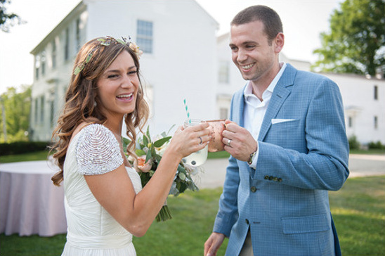 Bride and groom toasting drinks at outdoor wedding