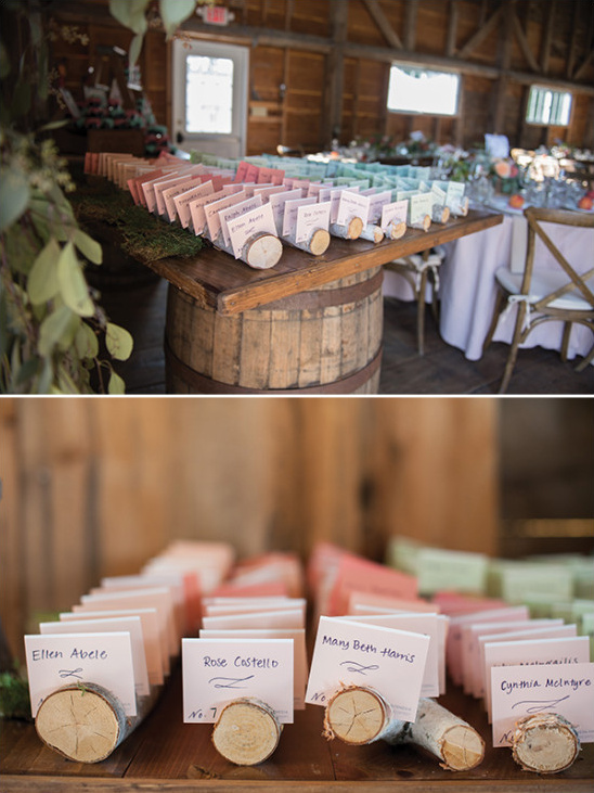 Rustic wedding place cards on a wooden barrel table