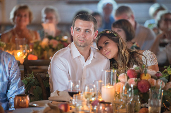 Couple celebrates at wedding reception table decor