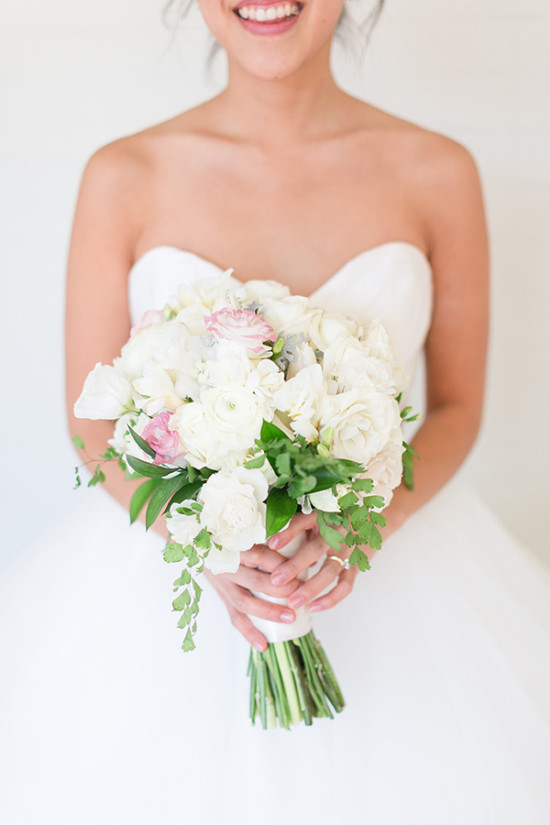 Bride holding beautiful white wedding bouquet