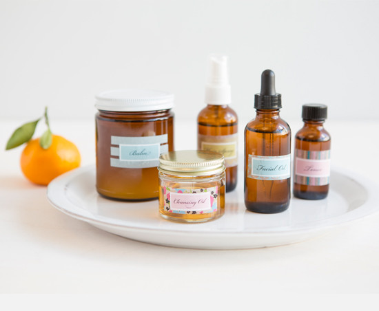Natural skincare products on white plate with orange