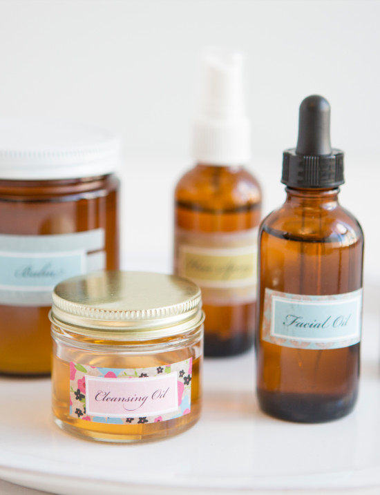 DIY skincare products oils and balms on a white tray