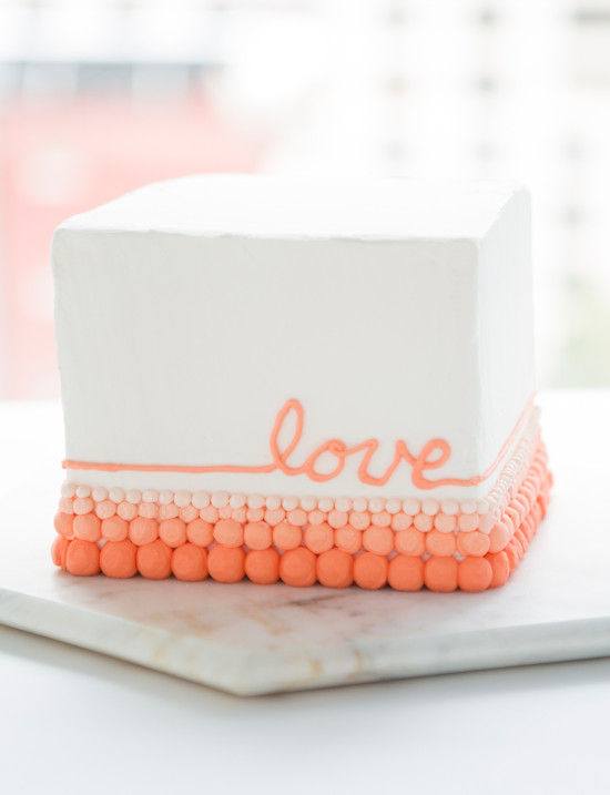 White square cake with peach love script and ball border