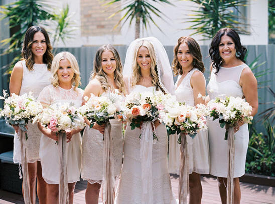 Bridesmaids in mismatched white dresses